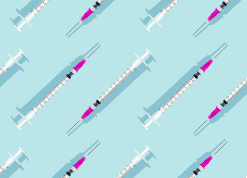Injectable syringes arranged in a pattern on a blue background
