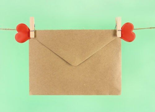 skincare routine love letter hanging on a clothesline with red hearts on a green background